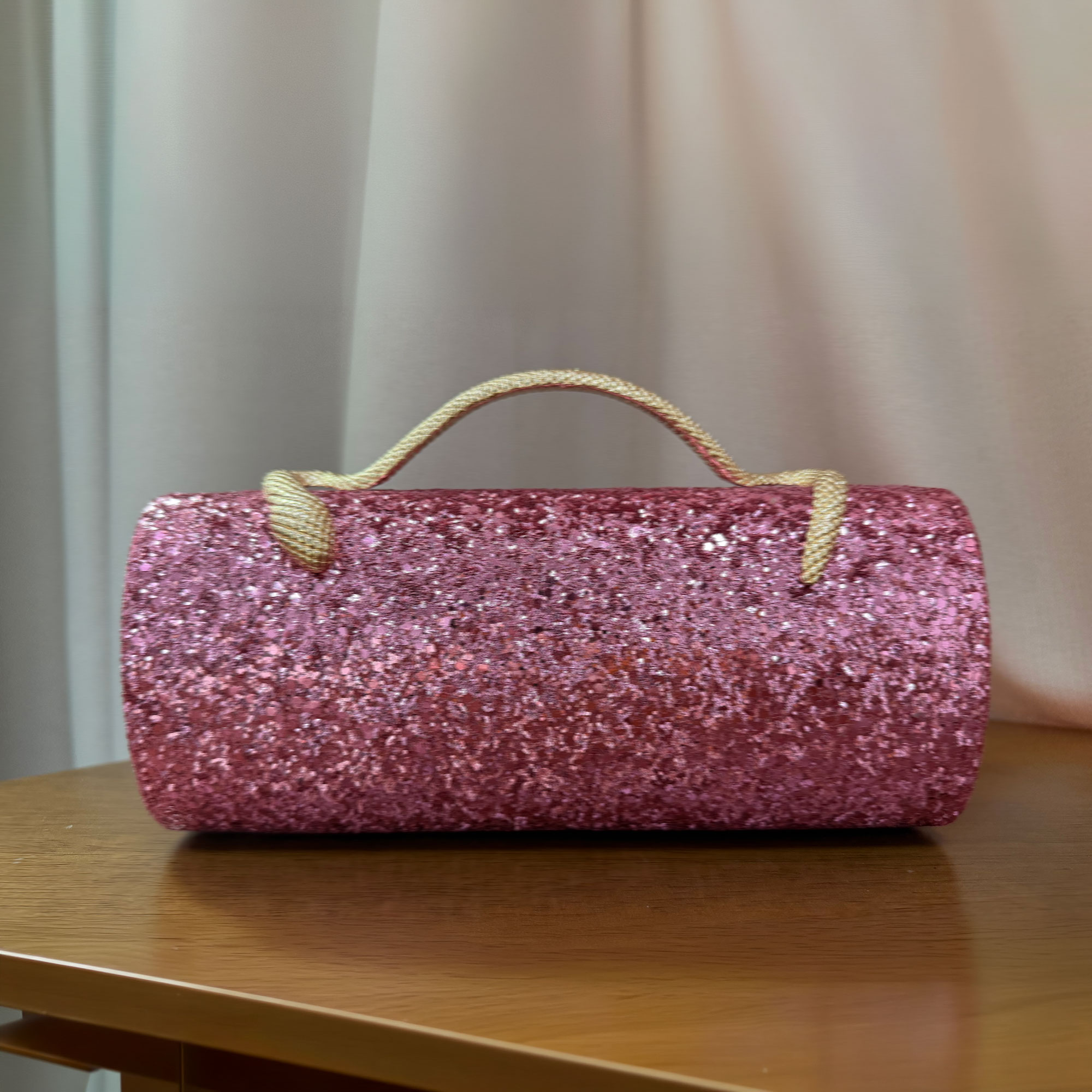 Supplied low-resolution reference of the Verano Hill pink glitter clutch on a wooden table
